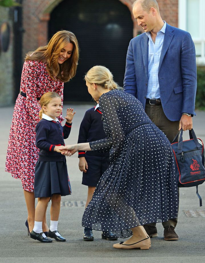 Charlotte is greeted by Helen Haslem, head of the lower school, on her arrival for her first day of school at Thomas's Batter
